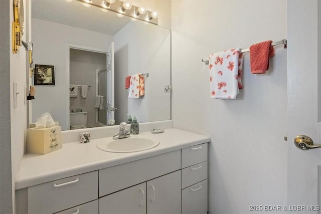 bathroom with toilet and vanity
