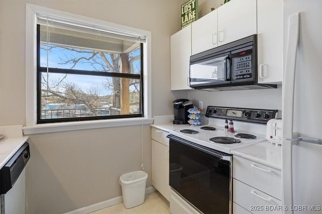 kitchen featuring white cabinets, white appliances, and light countertops