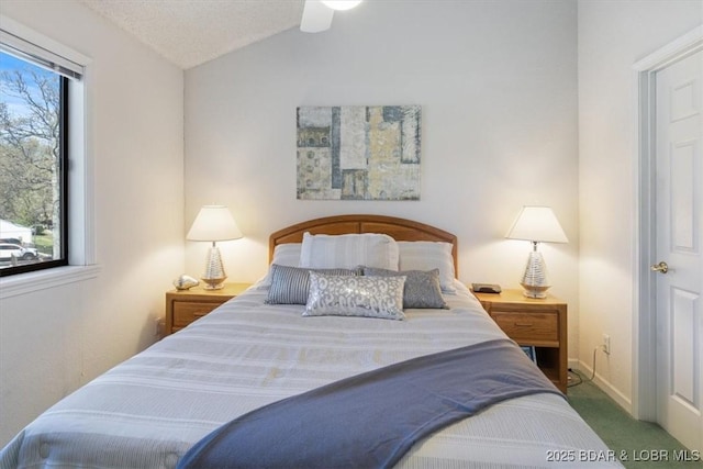 bedroom featuring vaulted ceiling, carpet floors, and baseboards