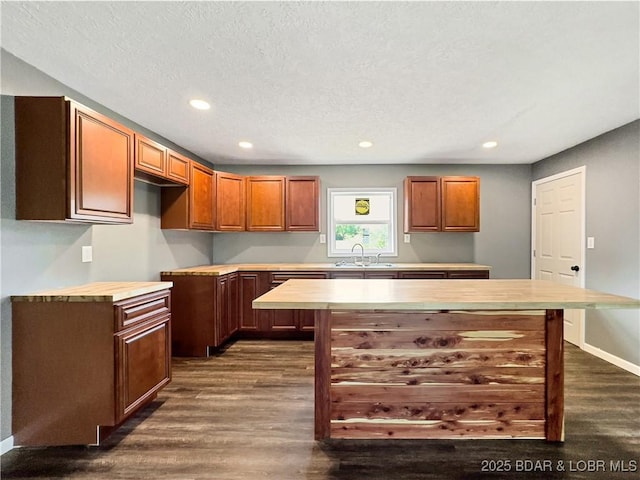 3053 Doc Ridgeway Dr, Roach, MO 65787 - kitchen with a sink, dark wood-style floors, recessed lighting, a center island, and wooden counters