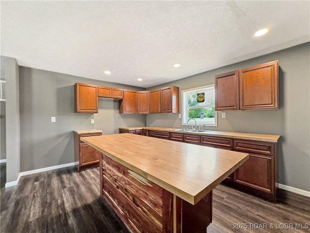 3053 Doc Ridgeway Dr, Roach, MO 65787 - kitchen featuring a sink, dark wood-style flooring, baseboards, a center island, and recessed lighting