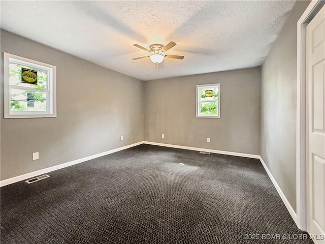 3053 Doc Ridgeway Dr, Roach, MO 65787 - spare room featuring a ceiling fan, baseboards, dark colored carpet, and a textured ceiling
