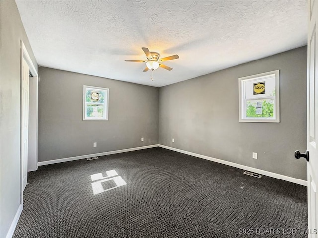 3053 Doc Ridgeway Dr, Roach, MO 65787 - empty room featuring dark colored carpet, a ceiling fan, baseboards, and a textured ceiling