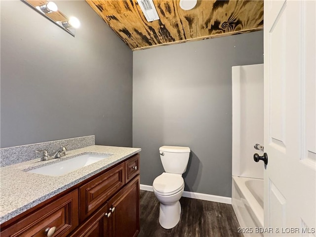 3053 Doc Ridgeway Dr, Roach, MO 65787 - full bathroom with wood finished floors, toilet, vanity, baseboards, and a bath
