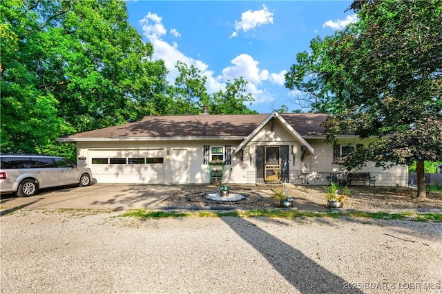 31945 Idle Wild Rd, Gravois Mills, MO 65037 - ranch-style house with an attached garage, driveway, and stucco siding