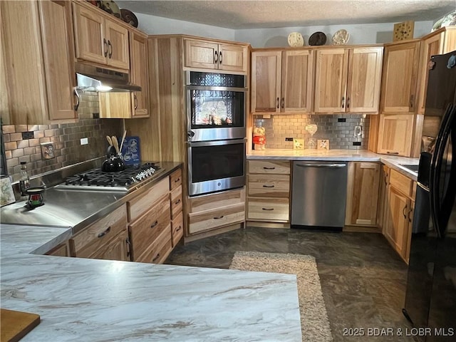 31945 Idle Wild Rd, Gravois Mills, MO 65037 - kitchen with light brown cabinets, a textured ceiling, under cabinet range hood, backsplash, and stainless steel appliances
