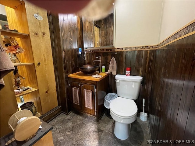 31945 Idle Wild Rd, Gravois Mills, MO 65037 - bathroom featuring wooden walls, a wainscoted wall, vanity, and toilet