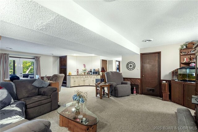 31945 Idle Wild Rd, Gravois Mills, MO 65037 - living area featuring carpet floors, a textured ceiling, visible vents, and wainscoting