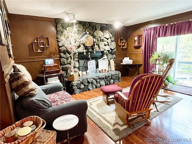 31945 Idle Wild Rd, Gravois Mills, MO 65037 - living area with a textured ceiling, wood finished floors, and a fireplace