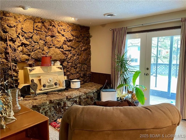 31945 Idle Wild Rd, Gravois Mills, MO 65037 - living area featuring a textured ceiling, plenty of natural light, french doors, and a wainscoted wall