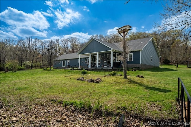 rear view of property with a lawn and covered porch