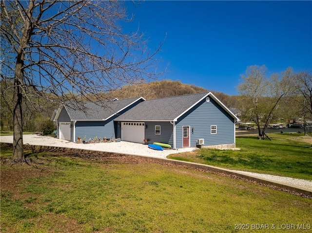 view of home's exterior with an attached garage, a yard, and gravel driveway