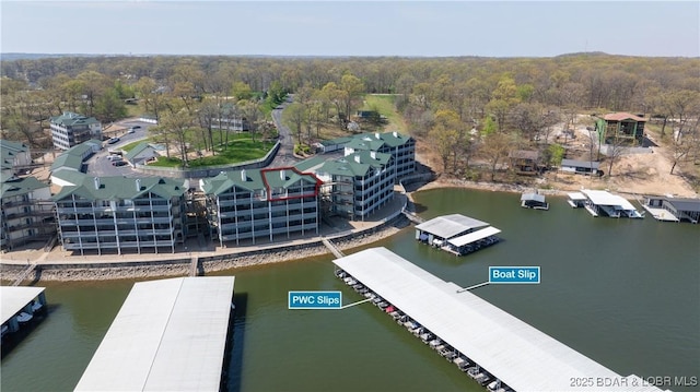 aerial view with a wooded view and a water view
