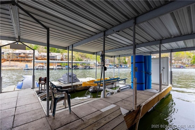 dock area with a water view and boat lift
