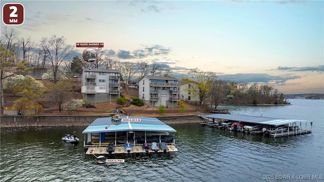 dock area with a water view and boat lift