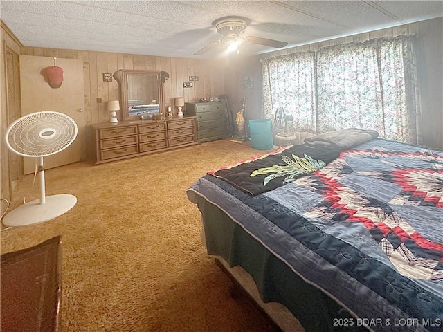 796 1051st Rd SE, Mo, MO 64740 - bedroom featuring wooden walls, carpet flooring, a textured ceiling, and a ceiling fan
