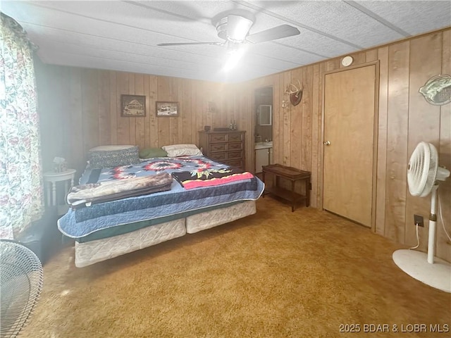 796 1051st Rd SE, Mo, MO 64740 - carpeted bedroom featuring ceiling fan, wood walls, and ensuite bathroom