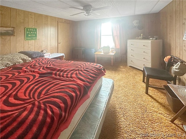 796 1051st Rd SE, Mo, MO 64740 - bedroom featuring ceiling fan, carpet floors, and wooden walls