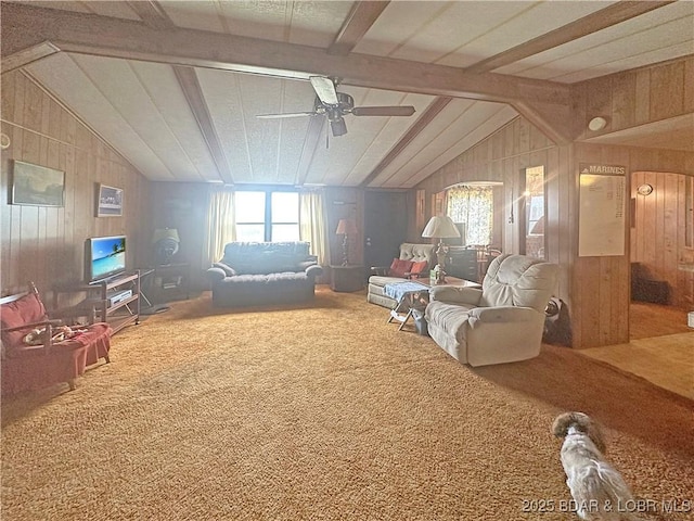 796 1051st Rd SE, Mo, MO 64740 - carpeted living area featuring vaulted ceiling with beams, wood walls, a ceiling fan, and a healthy amount of sunlight