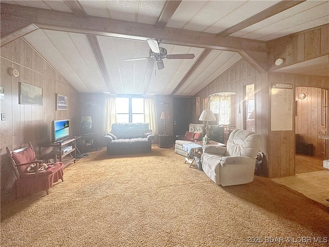 796 1051st Rd SE, Mo, MO 64740 - carpeted living area featuring ceiling fan, wood walls, and vaulted ceiling with beams