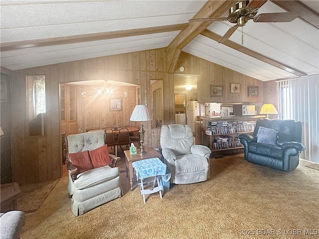 796 1051st Rd SE, Mo, MO 64740 - living area featuring carpet, wooden walls, a healthy amount of sunlight, a ceiling fan, and lofted ceiling with beams