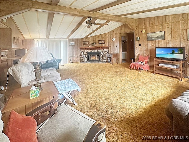796 1051st Rd SE, Mo, MO 64740 - carpeted living room with lofted ceiling with beams, a ceiling fan, wooden walls, and a stone fireplace