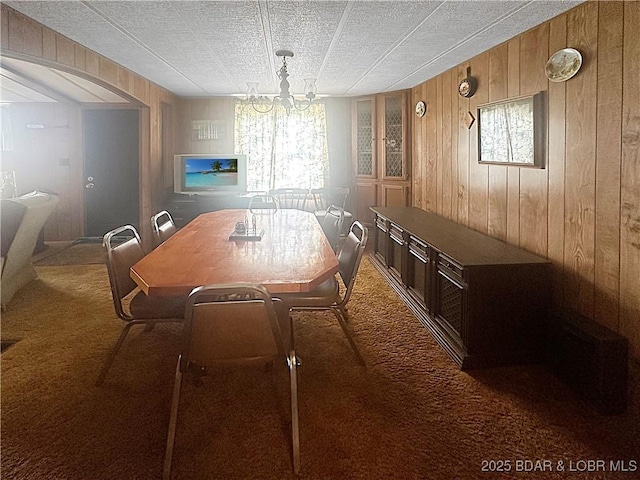 796 1051st Rd SE, Mo, MO 64740 - dining room with arched walkways, carpet flooring, and wooden walls