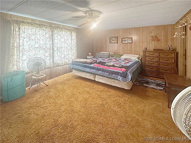 796 1051st Rd SE, Mo, MO 64740 - carpeted bedroom featuring wooden walls, a textured ceiling, and a ceiling fan