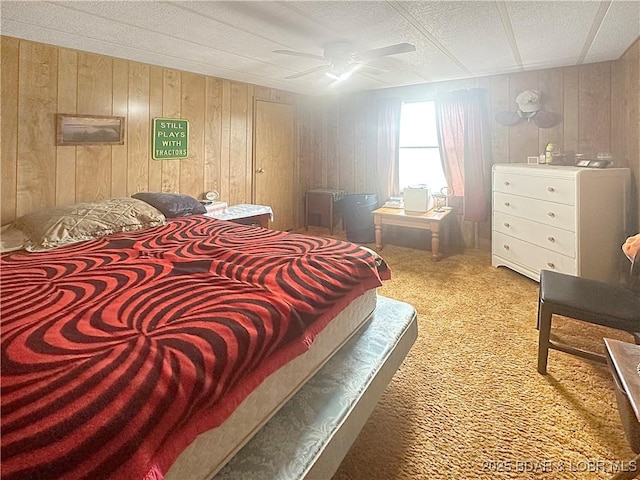 796 1051st Rd SE, Mo, MO 64740 - carpeted bedroom with a ceiling fan and wooden walls