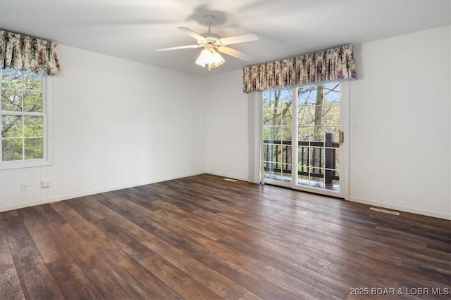 empty room featuring healthy amount of natural light, hardwood / wood-style floors, and a ceiling fan