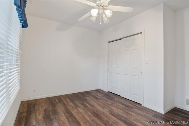 unfurnished bedroom with wood finished floors and baseboards