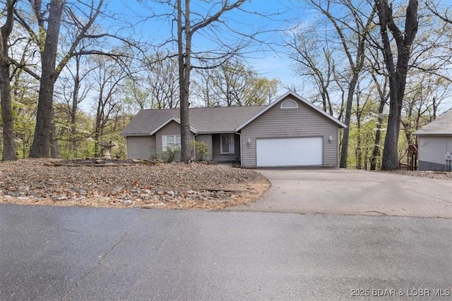 view of front of house featuring asphalt driveway and an attached garage
