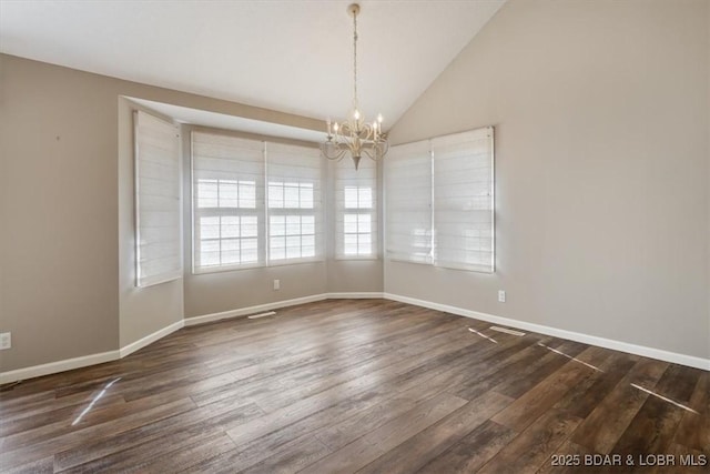 unfurnished room with a chandelier, dark wood-type flooring, vaulted ceiling, and baseboards