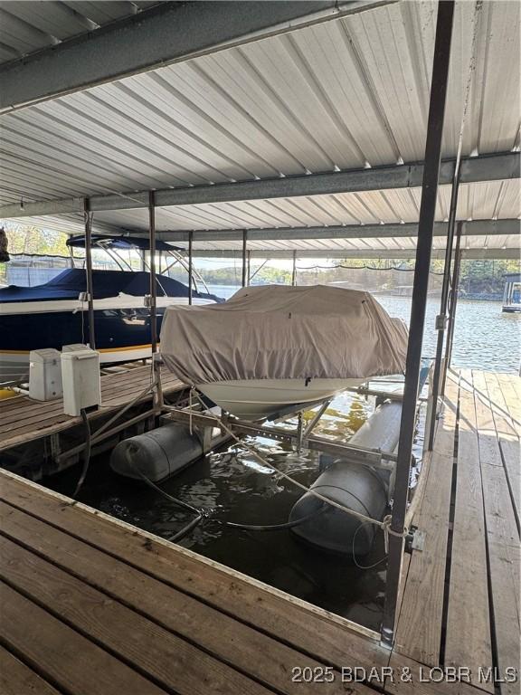 dock featuring boat lift and a water view