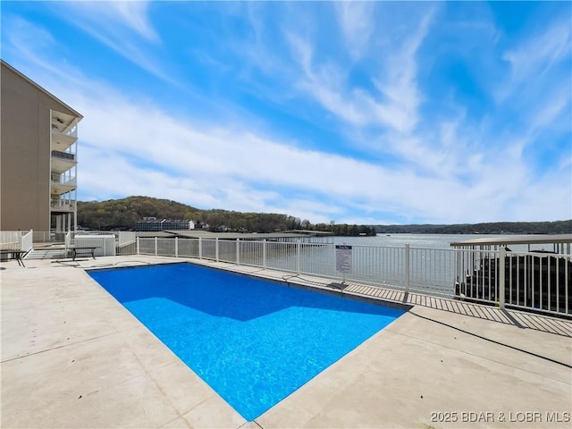 view of pool with a fenced in pool, a patio area, and fence
