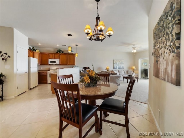 dining room with baseboards, recessed lighting, ceiling fan with notable chandelier, and light tile patterned flooring