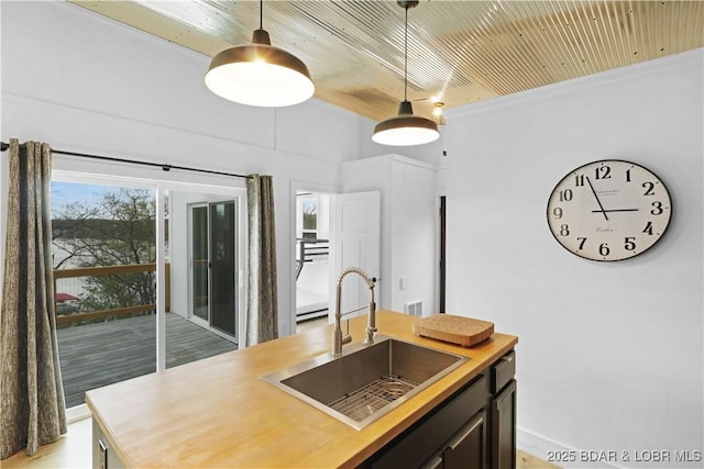 27205 Marina Ln, Barnett, MO 65011 - kitchen featuring hanging light fixtures, wood counters, wood ceiling, and a kitchen island with sink