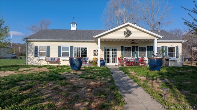 rear view of house with a chimney, french doors, a patio, ceiling fan, and roof with shingles