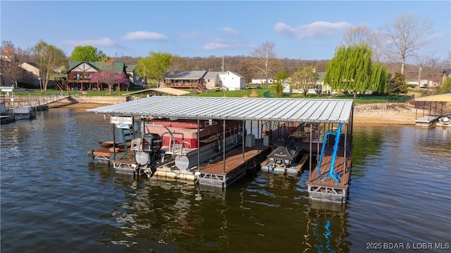 dock area with a water view and boat lift