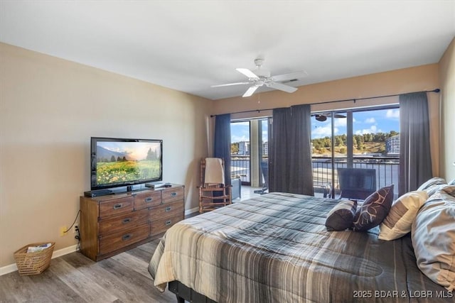 bedroom featuring ceiling fan, baseboards, wood finished floors, and access to exterior