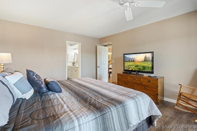 bedroom featuring ensuite bathroom, baseboards, ceiling fan, and dark wood finished floors
