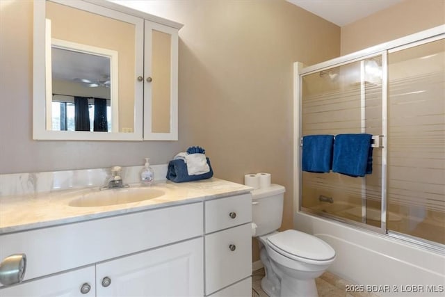 bathroom with toilet, vanity, tile patterned floors, and shower / bath combination with glass door