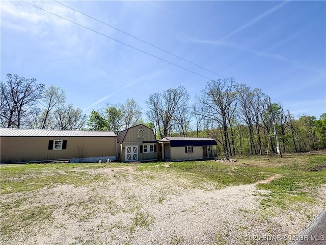 rear view of house featuring an outbuilding and a barn