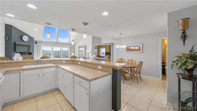 75 Cedar Heights Ln Unit 4D, Camdenton, MO 65020 - kitchen featuring light tile patterned floors, white dishwasher, a chandelier, pendant lighting, and recessed lighting
