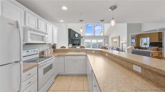 75 Cedar Heights Ln Unit 4D, Camdenton, MO 65020 - kitchen with white appliances, open floor plan, plenty of natural light, light tile patterned flooring, and vaulted ceiling