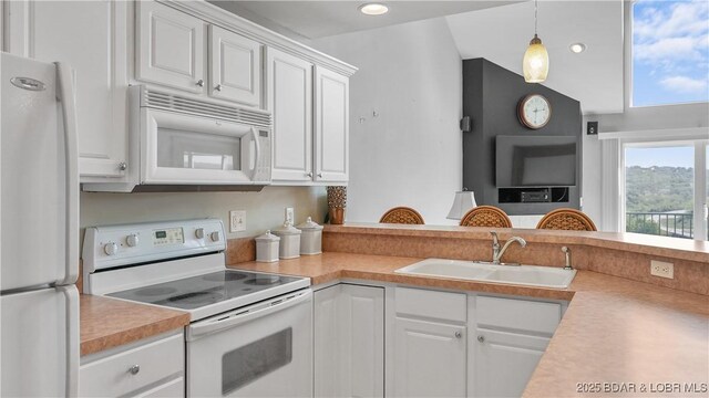 75 Cedar Heights Ln Unit 4D, Camdenton, MO 65020 - kitchen featuring white appliances, light countertops, white cabinetry, hanging light fixtures, and recessed lighting
