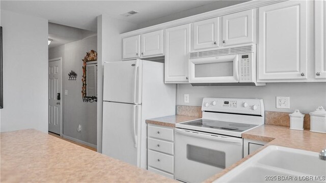 75 Cedar Heights Ln Unit 4D, Camdenton, MO 65020 - kitchen with white appliances, light countertops, and white cabinets