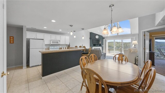 75 Cedar Heights Ln Unit 4D, Camdenton, MO 65020 - dining space featuring light tile patterned flooring, a chandelier, recessed lighting, and a water view