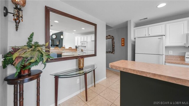 75 Cedar Heights Ln Unit 4D, Camdenton, MO 65020 - kitchen featuring white appliances, recessed lighting, light tile patterned floors, white cabinetry, and light countertops