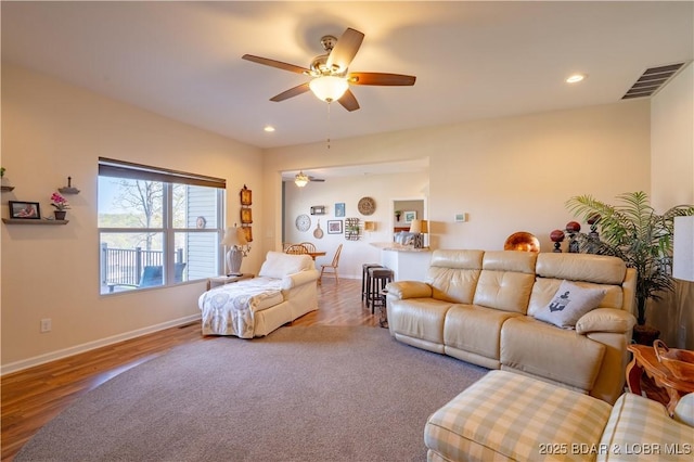 living room featuring a ceiling fan, wood finished floors, baseboards, and recessed lighting